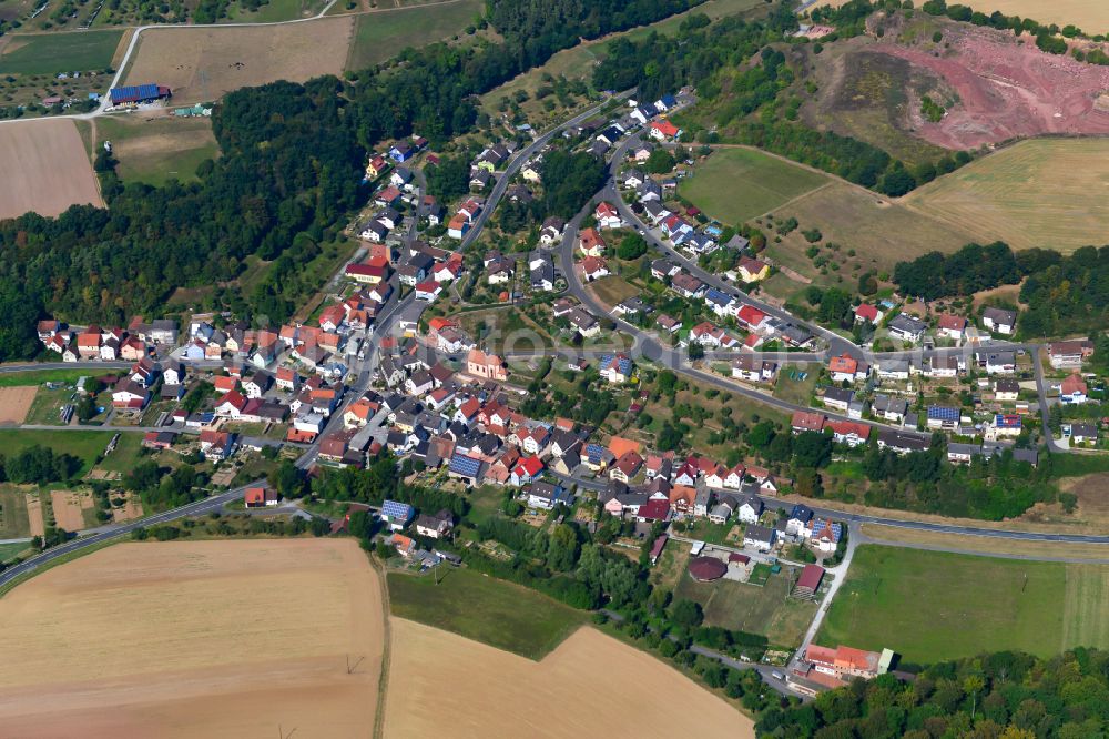 Wüstenzell from above - Agricultural land and field boundaries surround the settlement area of the village in Wüstenzell in the state Bavaria, Germany