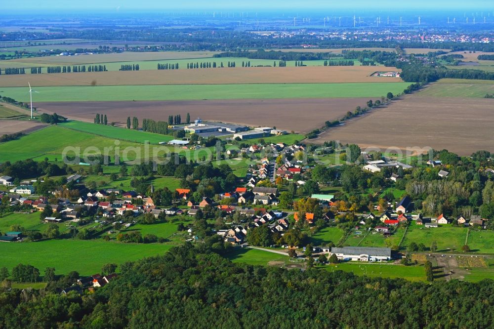 Wulkow from the bird's eye view: Agricultural land and field boundaries surround the settlement area of the village in Wulkow in the state Brandenburg, Germany