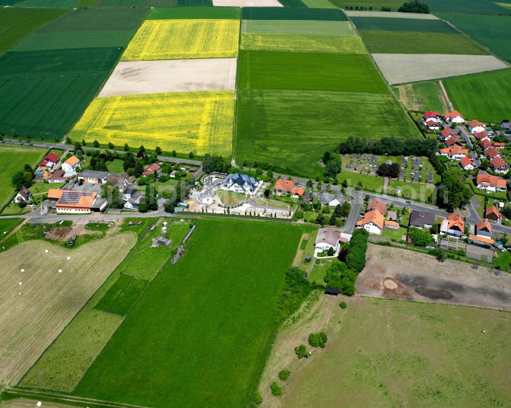 Aerial photograph Zell - Agricultural land and field boundaries surround the settlement area of the village in Zell in the state Hesse, Germany