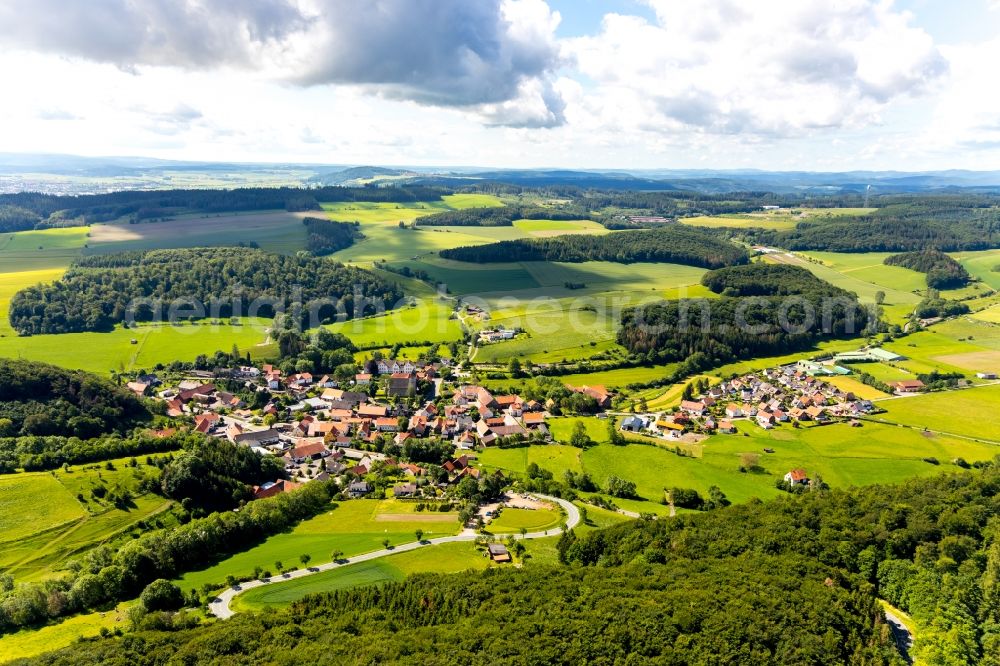 Flechtdorf from the bird's eye view: Agricultural land and field borders surround the settlement area of the village in Flechtdorf in the state Hesse, Germany