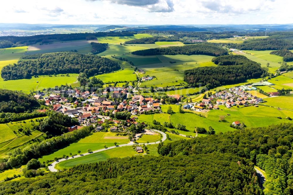 Aerial image Flechtdorf - Agricultural land and field borders surround the settlement area of the village in Flechtdorf in the state Hesse, Germany