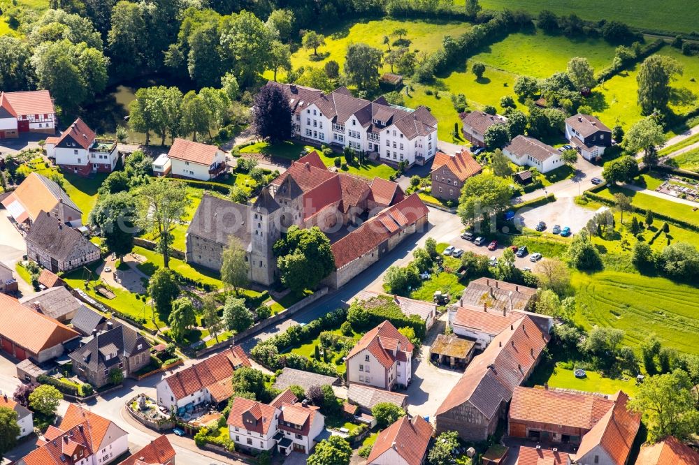 Flechtdorf from the bird's eye view: Agricultural land and field borders surround the settlement area of the village in Flechtdorf in the state Hesse, Germany