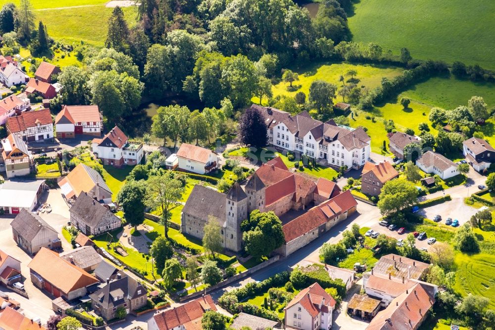 Aerial image Flechtdorf - Agricultural land and field borders surround the settlement area of the village in Flechtdorf in the state Hesse, Germany