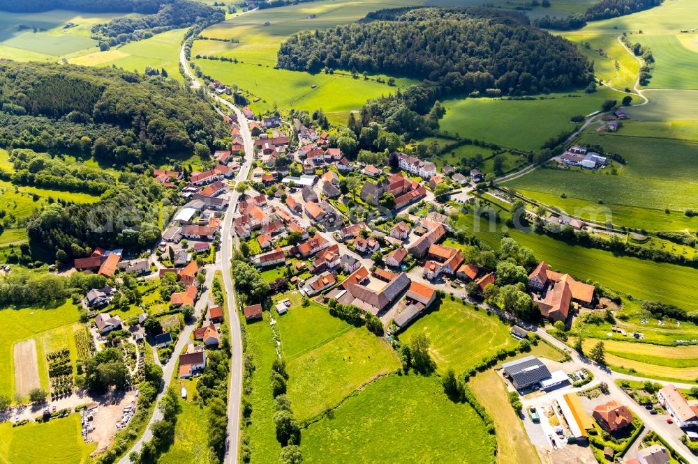 Aerial photograph Flechtdorf - Agricultural land and field borders surround the settlement area of the village in Flechtdorf in the state Hesse, Germany