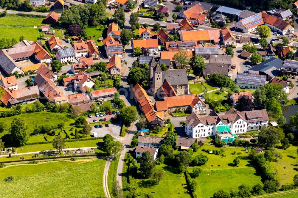 Flechtdorf from above - Agricultural land and field borders surround the settlement area of the village in Flechtdorf in the state Hesse, Germany