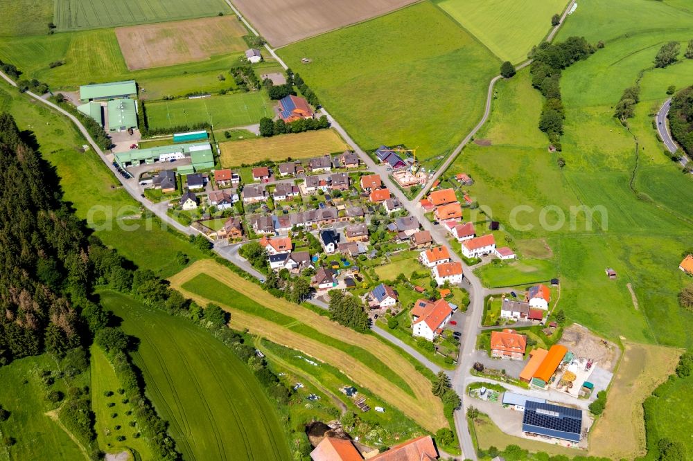 Aerial image Flechtdorf - Agricultural land and field borders surround the settlement area of the village in Flechtdorf in the state Hesse, Germany