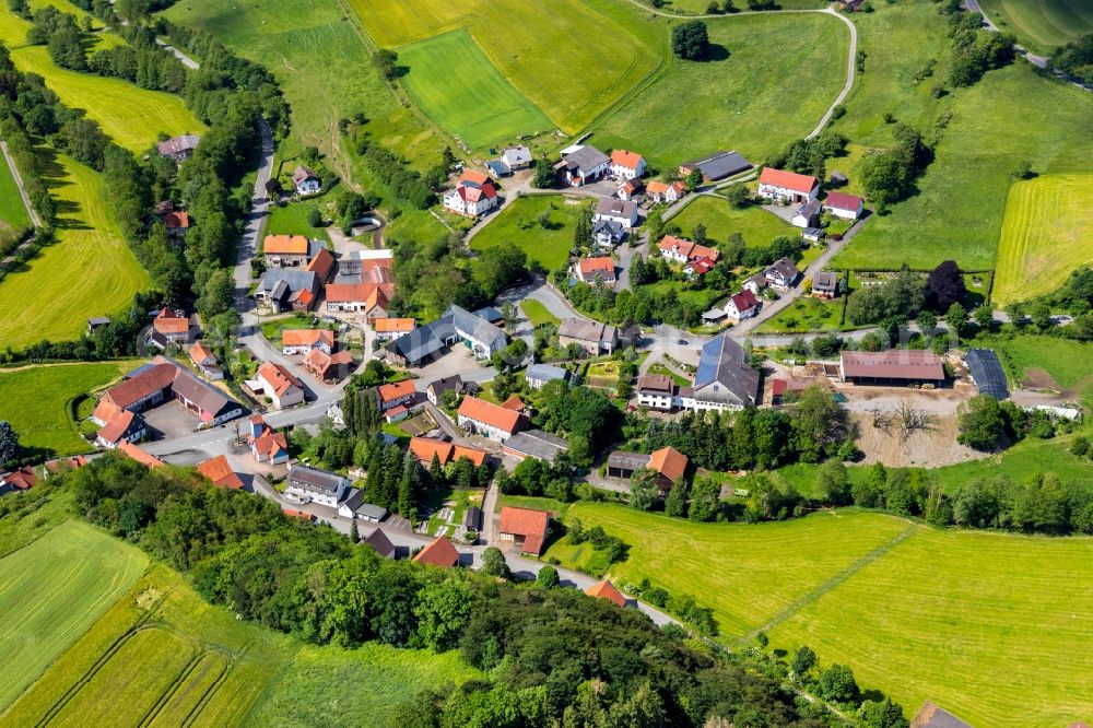 Aerial image Giebringhausen - Agricultural land and field borders surround the settlement area of the village in Giebringhausen in the state Hesse, Germany