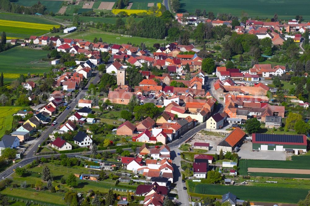 Grabe from above - Agricultural land and field borders surround the settlement area of the village in Grabe in the state Thuringia, Germany