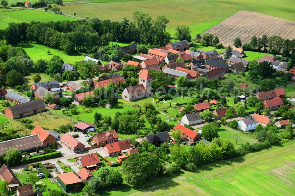 Aerial image Groß Leppin - Agricultural land and field borders surround the settlement area of the village in Gross Leppin in the state Brandenburg, Germany