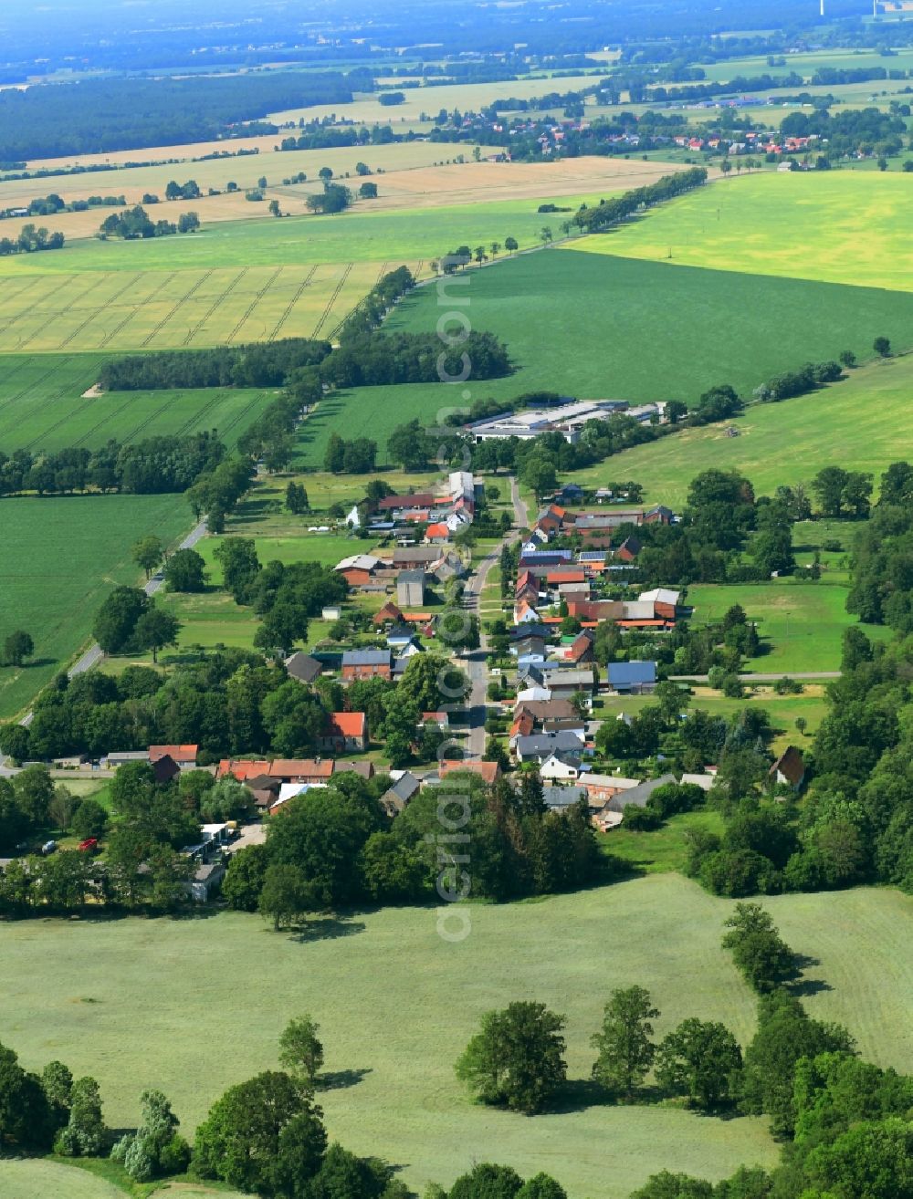 Gulow from above - Agricultural land and field borders surround the settlement area of the village in Gulow in the state Brandenburg, Germany