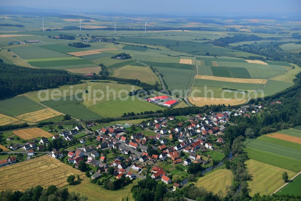 Aerial photograph Haueda - Agricultural land and field borders surround the settlement area of the village in Haueda in the state Hesse, Germany