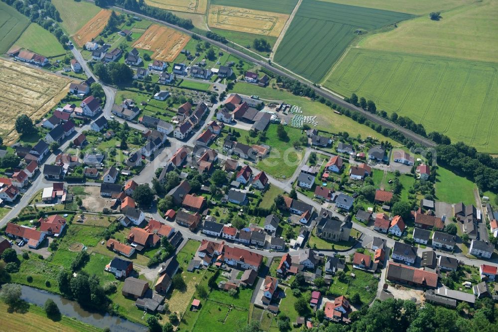 Aerial photograph Haueda - Agricultural land and field borders surround the settlement area of the village in Haueda in the state Hesse, Germany