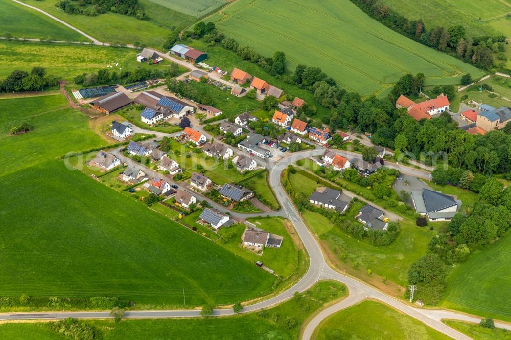 Aerial image Helmighausen - Agricultural land and field borders surround the settlement area of the village in Helmighausen in the state Hesse, Germany