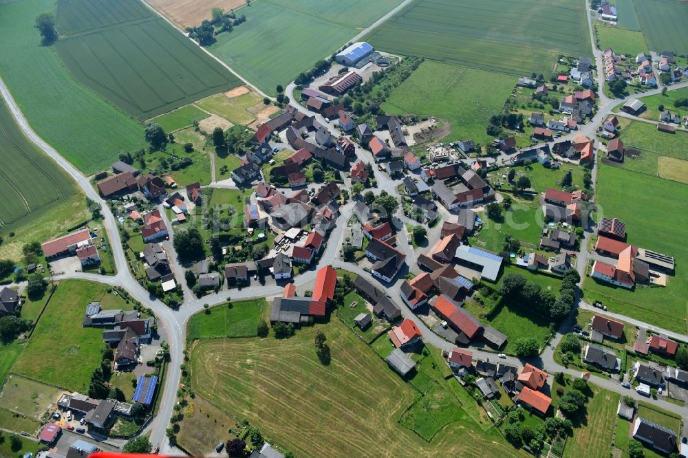 Aerial photograph Herbsen - Agricultural land and field borders surround the settlement area of the village in Herbsen in the state Hesse, Germany