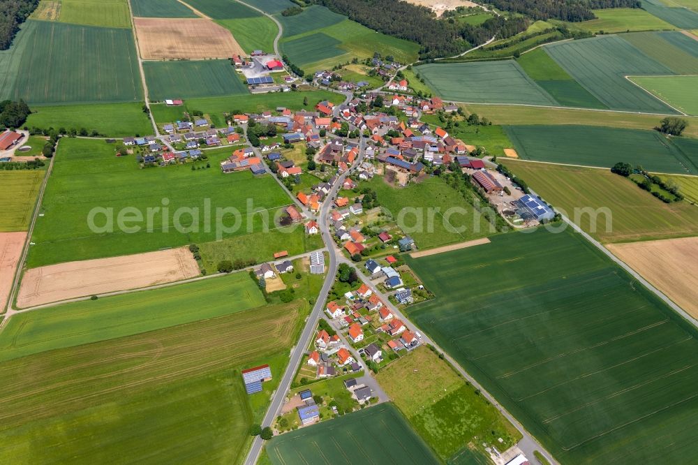 Herbsen from the bird's eye view: Agricultural land and field borders surround the settlement area of the village in Herbsen in the state Hesse, Germany