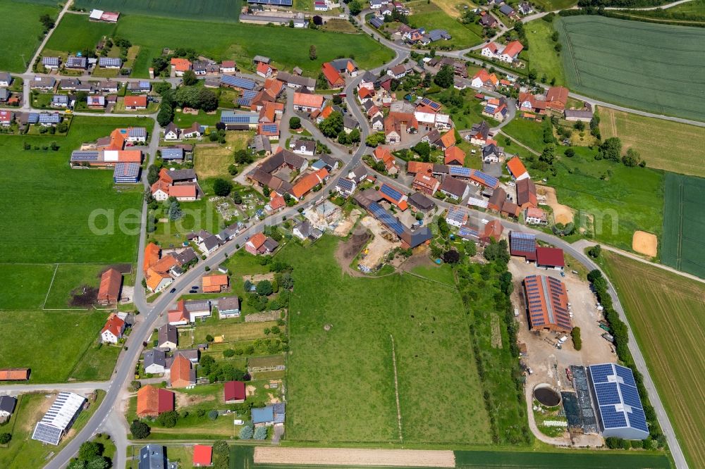 Aerial photograph Herbsen - Agricultural land and field borders surround the settlement area of the village in Herbsen in the state Hesse, Germany