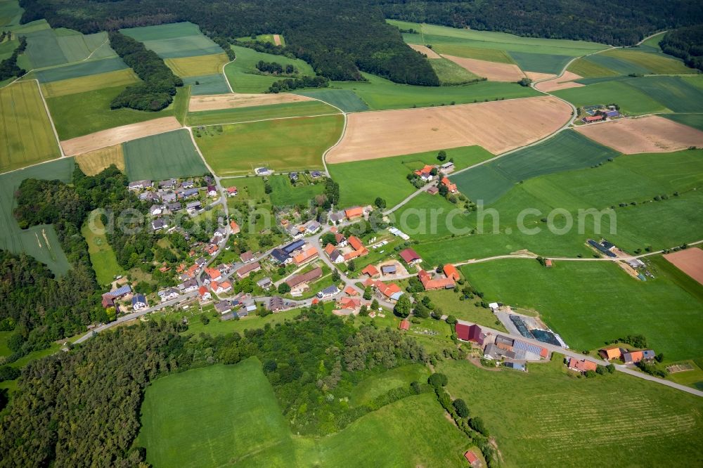 Hörle from the bird's eye view: Agricultural land and field borders surround the settlement area of the village in Hoerle in the state Hesse, Germany