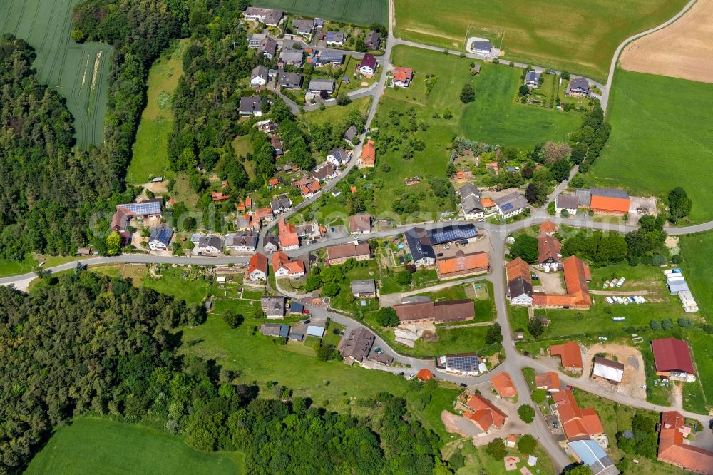 Hörle from above - Agricultural land and field borders surround the settlement area of the village in Hoerle in the state Hesse, Germany