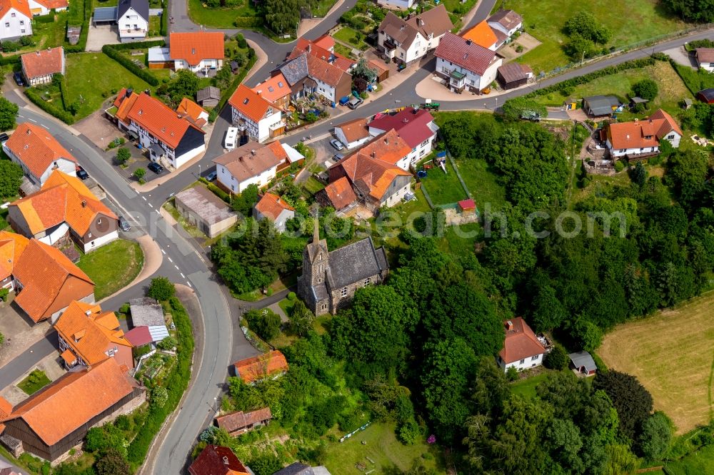 Hundsdorf from above - Agricultural land and field borders surround the settlement area of the village in Hundsdorf in the state Hesse, Germany