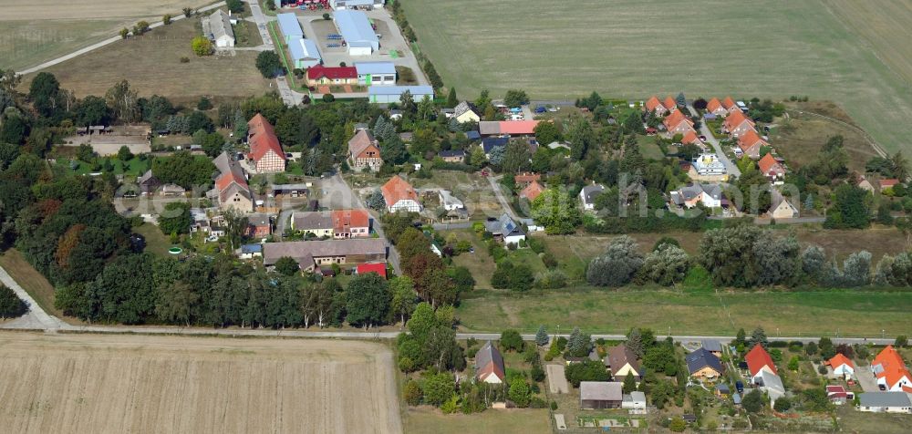 Karlshof from the bird's eye view: Agricultural land and field borders surround the settlement area of the village in Karlshof in the state Brandenburg, Germany