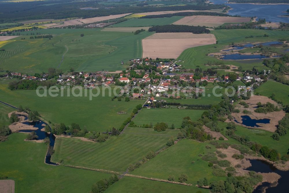 Ketzür from above - Agricultural land and field borders surround the settlement area of the village in Ketzuer in the state Brandenburg, Germany