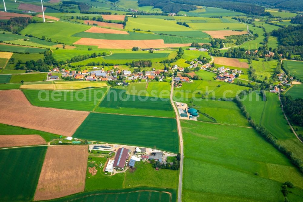 Aerial image Kohlgrund - Agricultural land and field borders surround the settlement area of the village in Kohlgrund in the state Hesse, Germany