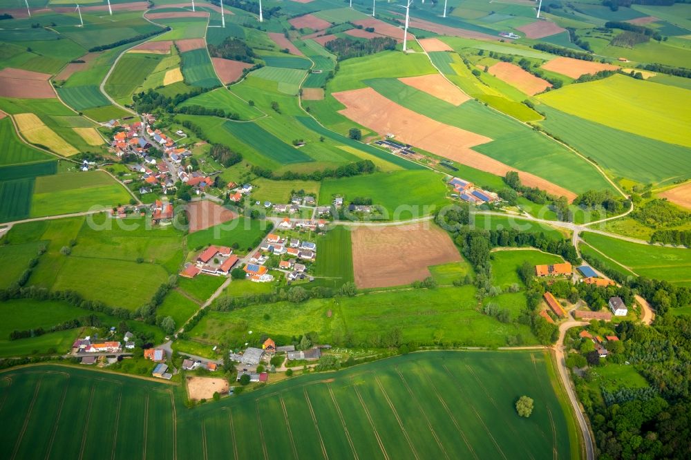 Aerial image Kohlgrund - Agricultural land and field borders surround the settlement area of the village in Kohlgrund in the state Hesse, Germany