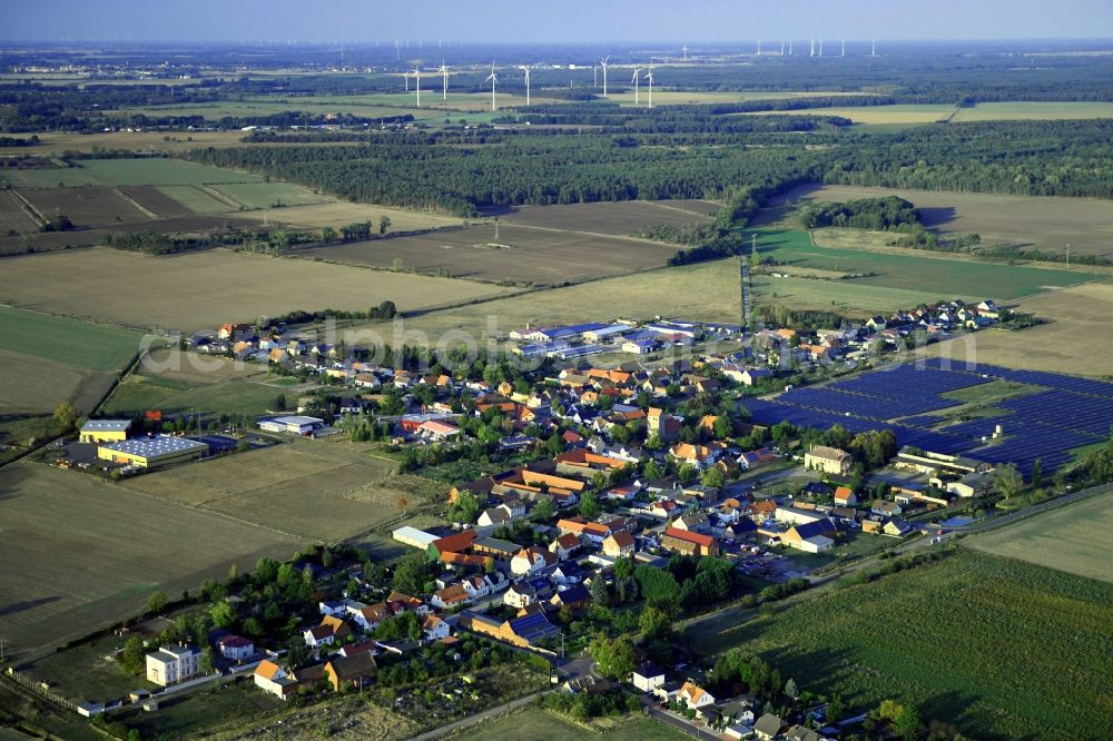 Körbelitz from the bird's eye view: Agricultural land and field borders surround the settlement area of the village in Koerbelitz in the state Saxony-Anhalt, Germany