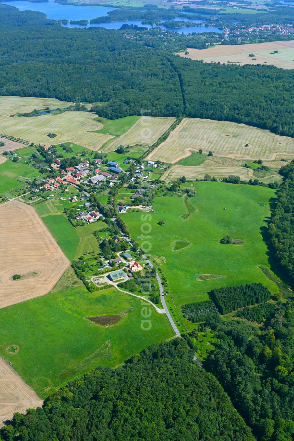 Aerial photograph Lüttenhagen - Agricultural land and field borders surround the settlement area of the village in Luettenhagen in the state Mecklenburg - Western Pomerania, Germany