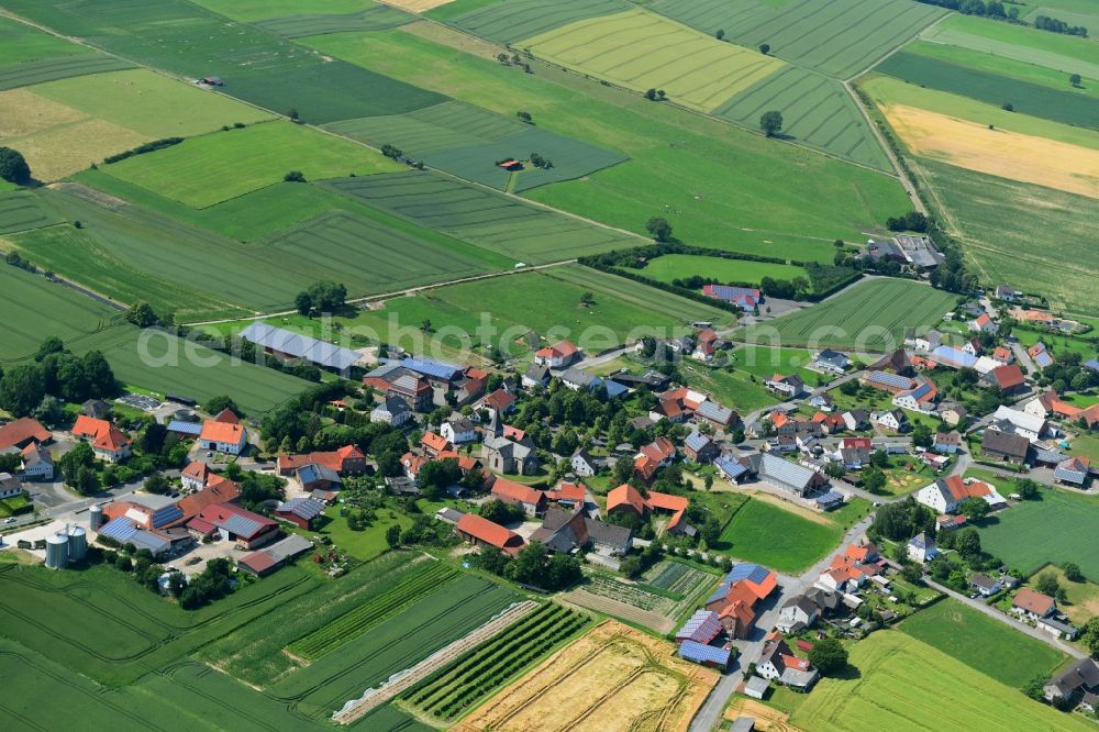 Löwen from above - Agricultural land and field borders surround the settlement area of the village in Loewen in the state North Rhine-Westphalia, Germany