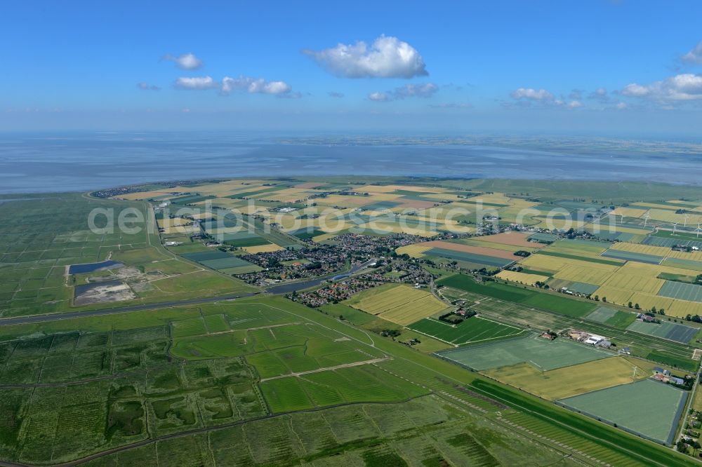 Friedrichskoog from the bird's eye view: Village on marine coastal area of North Sea in Friedrichskoog in the state Schleswig-Holstein