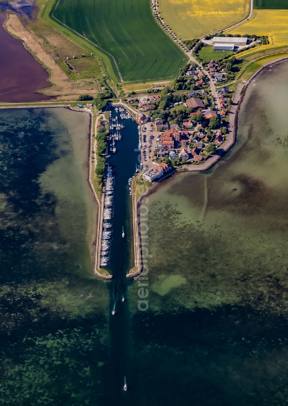 Fehmarn from the bird's eye view: Village center on the coastal area of the Baltic Sea in Orth auf Fehmarn in the state Schleswig-Holstein, Germany. The port and fishing village is located on the Orth Bay in the western part of the island of Fehmarn