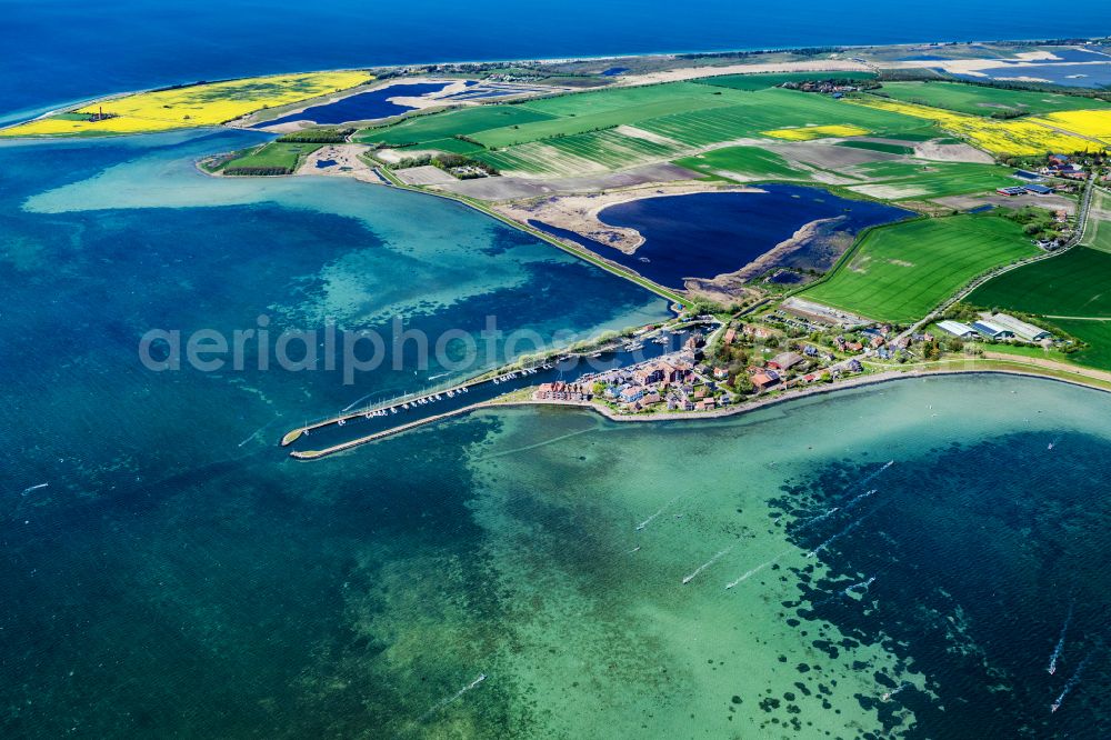 Fehmarn from the bird's eye view: Village center on the coastal area of the Baltic Sea in Orth auf Fehmarn in the state Schleswig-Holstein, Germany. The port and fishing village is located on the Orth Bay in the western part of the island of Fehmarn