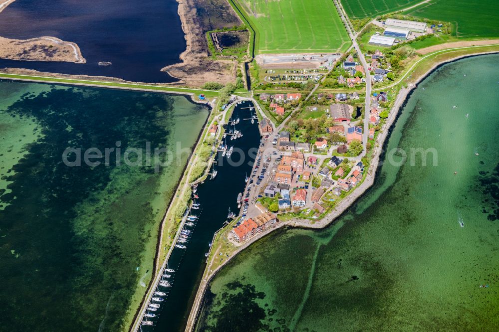 Aerial photograph Fehmarn - Village center on the coastal area of the Baltic Sea in Orth auf Fehmarn in the state Schleswig-Holstein, Germany. The port and fishing village is located on the Orth Bay in the western part of the island of Fehmarn