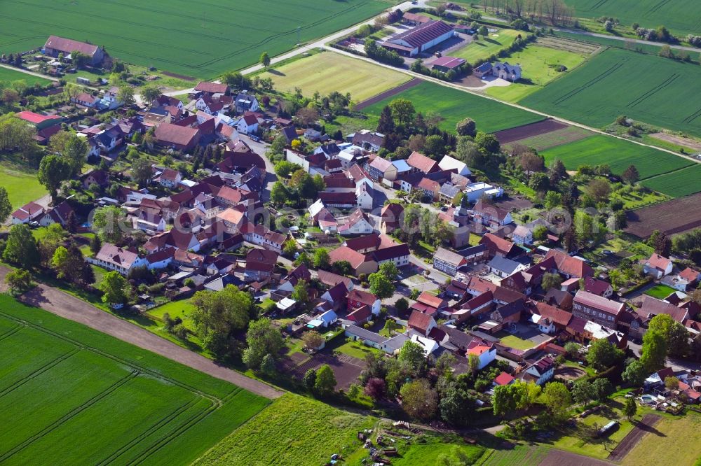 Aerial image Mehrstedt - Agricultural land and field borders surround the settlement area of the village in Mehrstedt in the state Thuringia, Germany