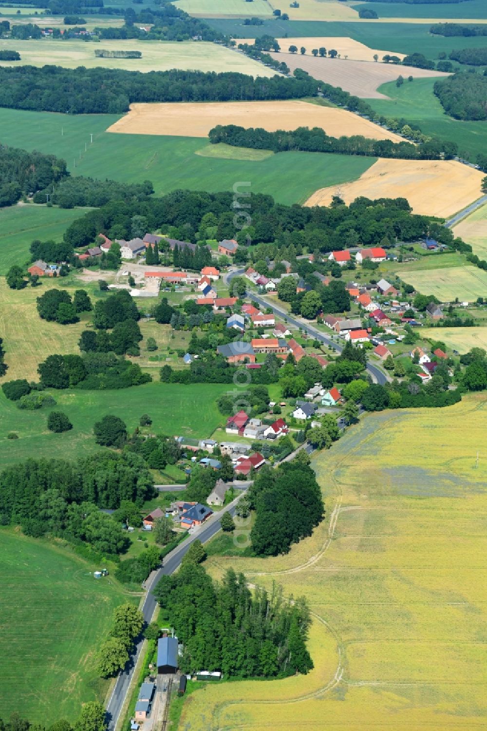 Mesendorf from above - Agricultural land and field borders surround the settlement area of the village in Mesendorf in the state Brandenburg, Germany