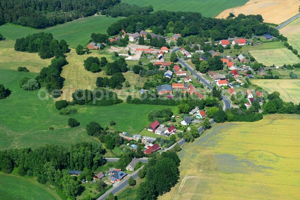 Aerial image Mesendorf - Agricultural land and field borders surround the settlement area of the village in Mesendorf in the state Brandenburg, Germany