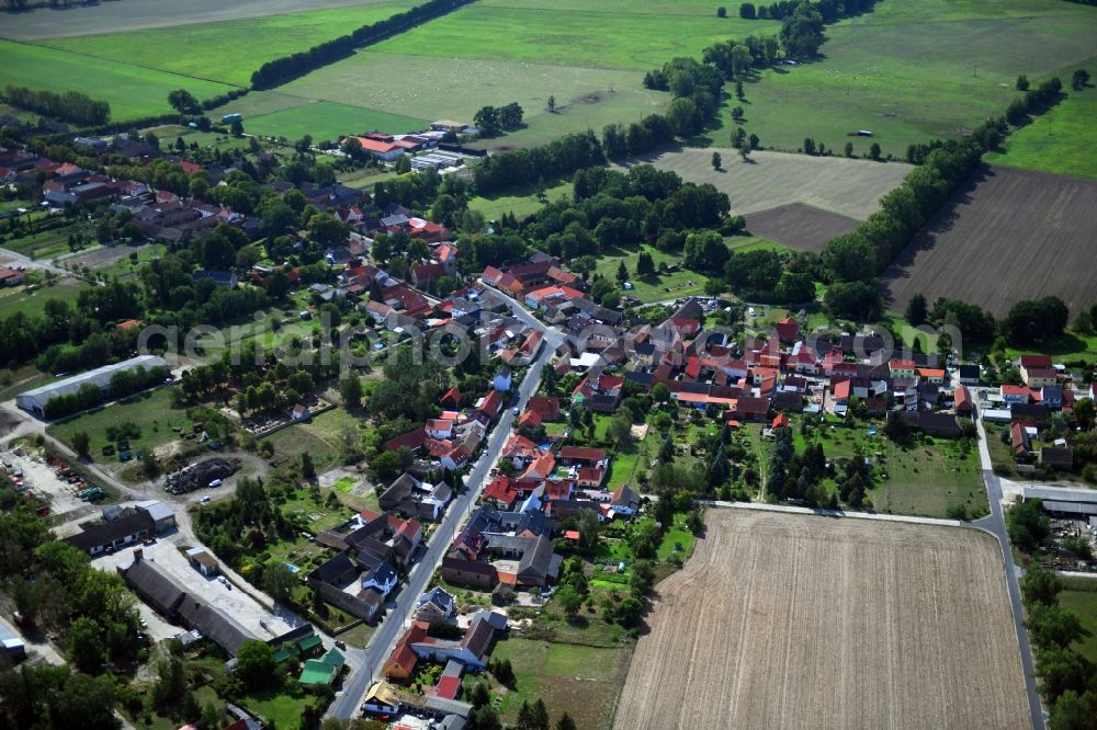 Mühlenfließ from the bird's eye view: Agricultural land and field borders surround the settlement area of the village in Muehlenfliess in the state Brandenburg, Germany