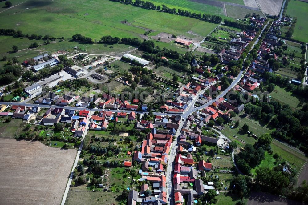 Aerial image Mühlenfließ - Agricultural land and field borders surround the settlement area of the village in Muehlenfliess in the state Brandenburg, Germany