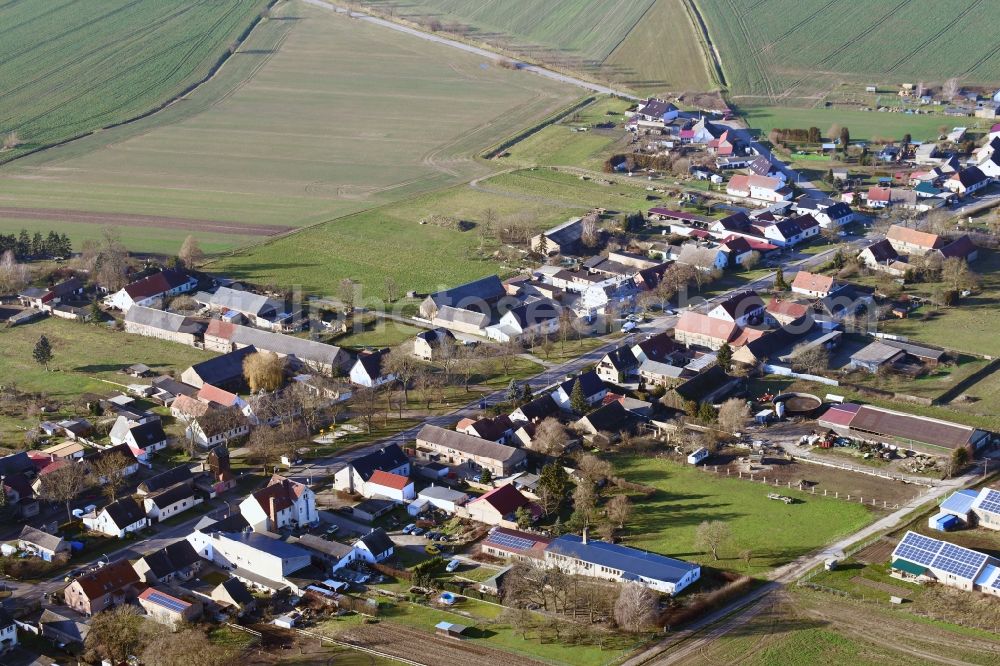 Mildenberg from above - Agricultural land and field borders surround the settlement area of the village in Mildenberg in the state Brandenburg, Germany