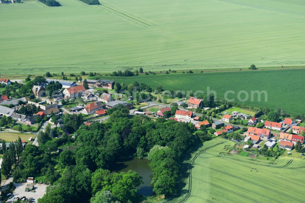 Aerial image Mulmke - Agricultural land and field borders surround the settlement area of the village in Mulmke in the state Saxony-Anhalt, Germany