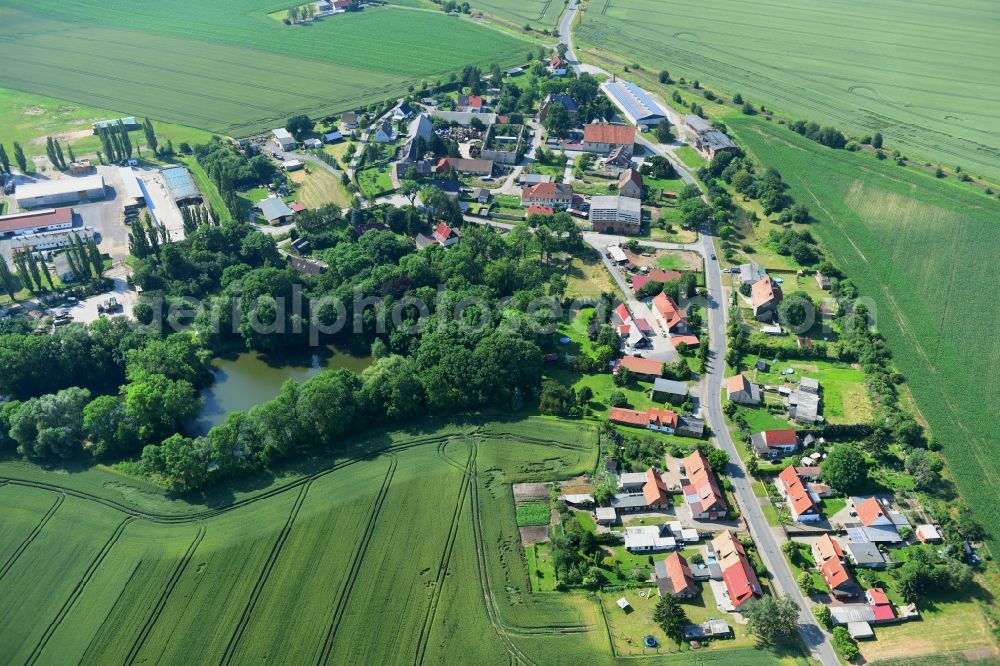 Aerial photograph Mulmke - Agricultural land and field borders surround the settlement area of the village in Mulmke in the state Saxony-Anhalt, Germany