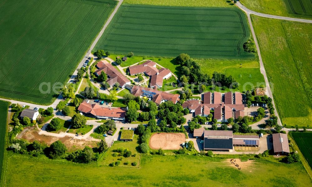 Aerial image Neu-Berich - Agricultural land and field borders surround the settlement area of the village in Neu-Berich in the state Hesse, Germany