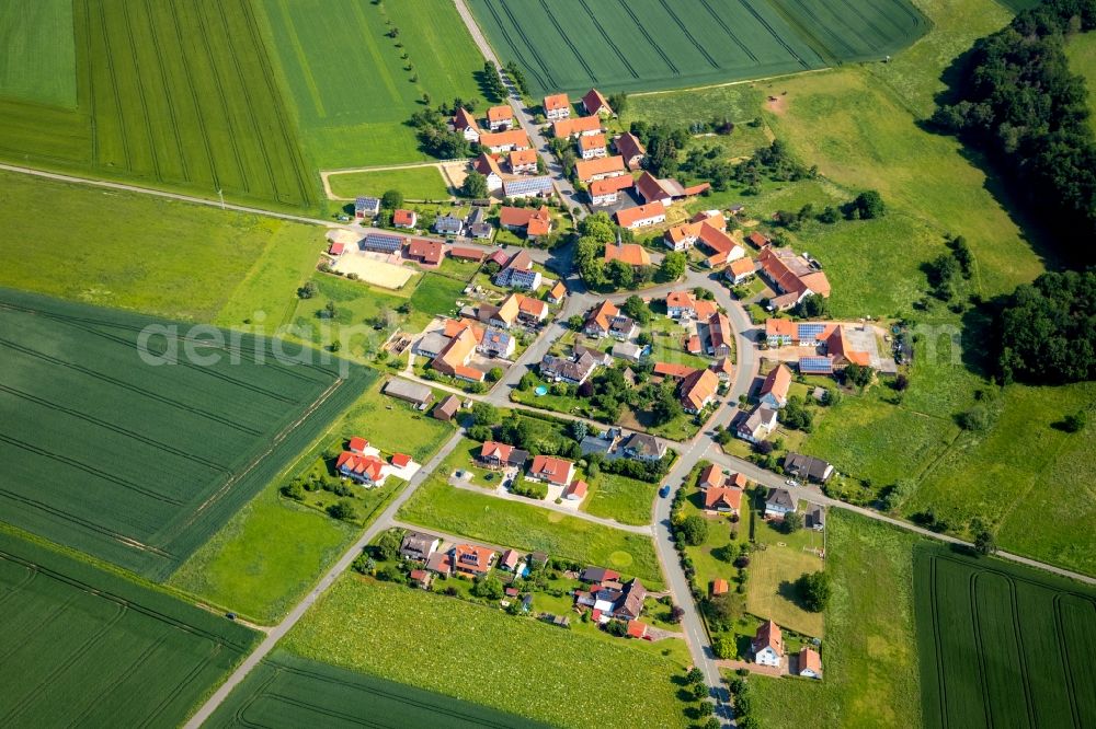 Neu-Berich from the bird's eye view: Agricultural land and field borders surround the settlement area of the village in Neu-Berich in the state Hesse, Germany