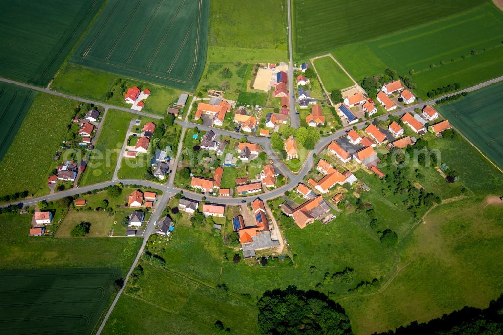 Aerial image Neu-Berich - Agricultural land and field borders surround the settlement area of the village in Neu-Berich in the state Hesse, Germany