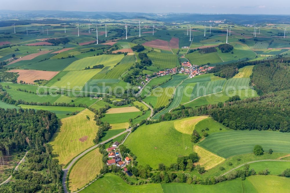 Aerial photograph Neudorf - Agricultural land and field borders surround the settlement area of the village in Neudorf in the state Hesse, Germany