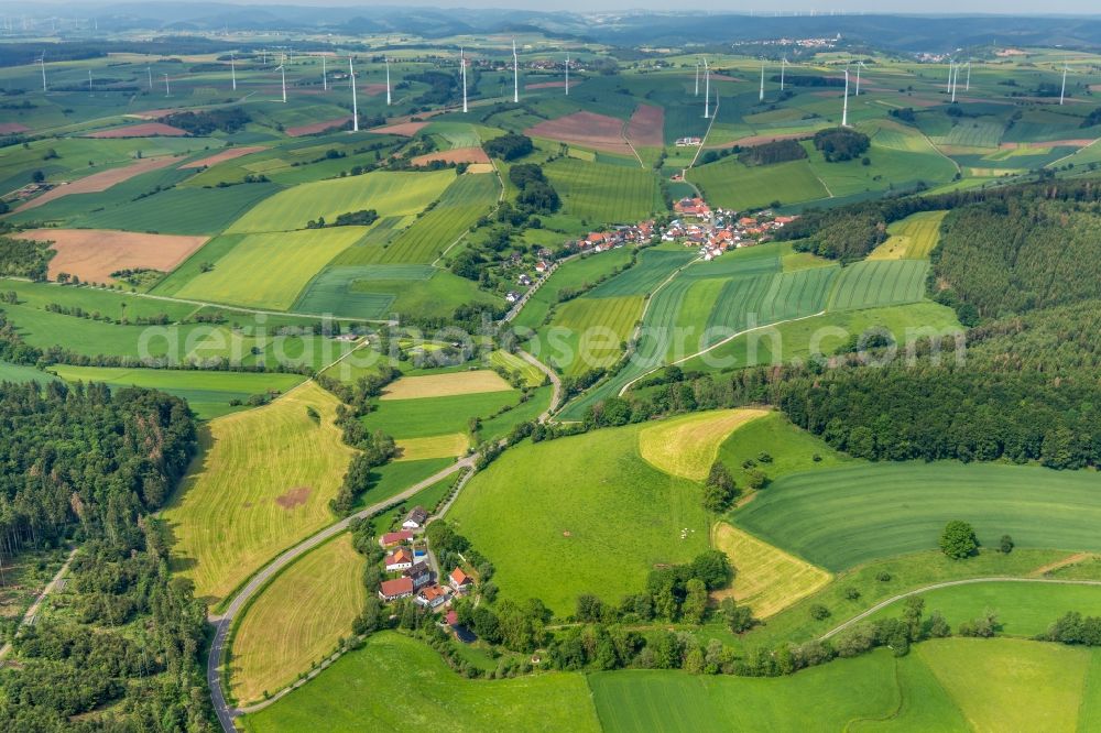 Neudorf from above - Agricultural land and field borders surround the settlement area of the village in Neudorf in the state Hesse, Germany