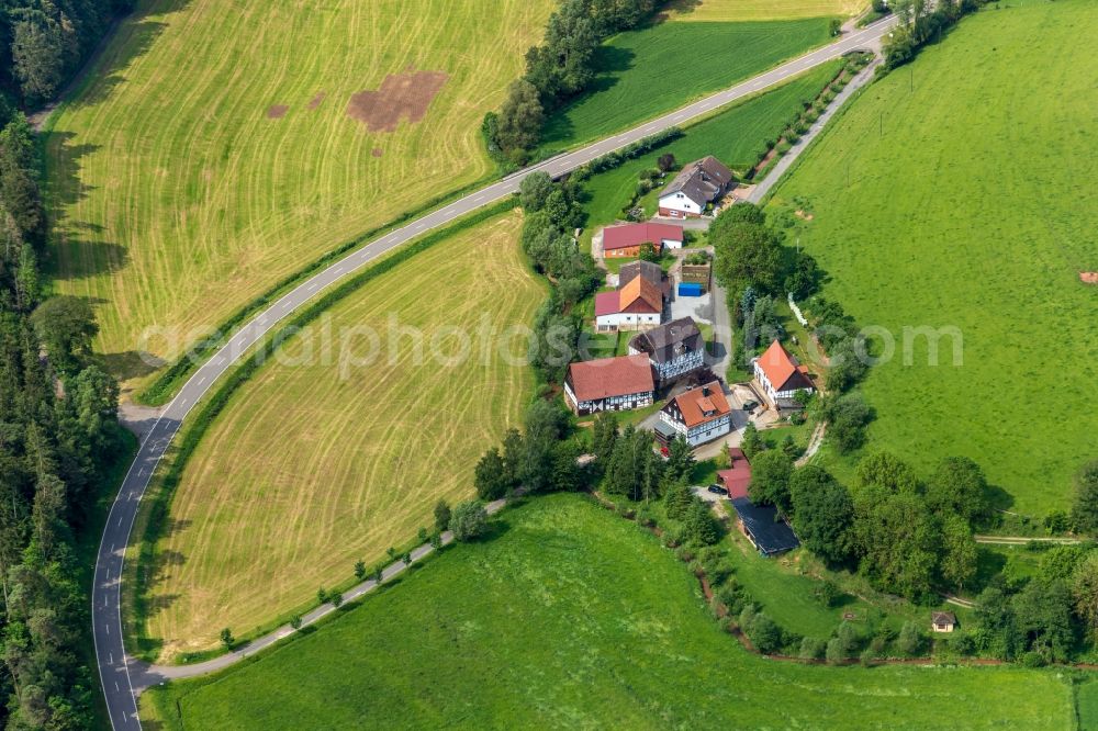 Neudorf from the bird's eye view: Agricultural land and field borders surround the settlement area of the village in Neudorf in the state Hesse, Germany