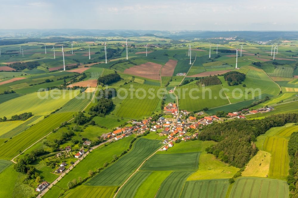 Aerial image Neudorf - Agricultural land and field borders surround the settlement area of the village in Neudorf in the state Hesse, Germany