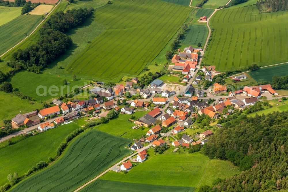 Aerial photograph Neudorf - Agricultural land and field borders surround the settlement area of the village in Neudorf in the state Hesse, Germany